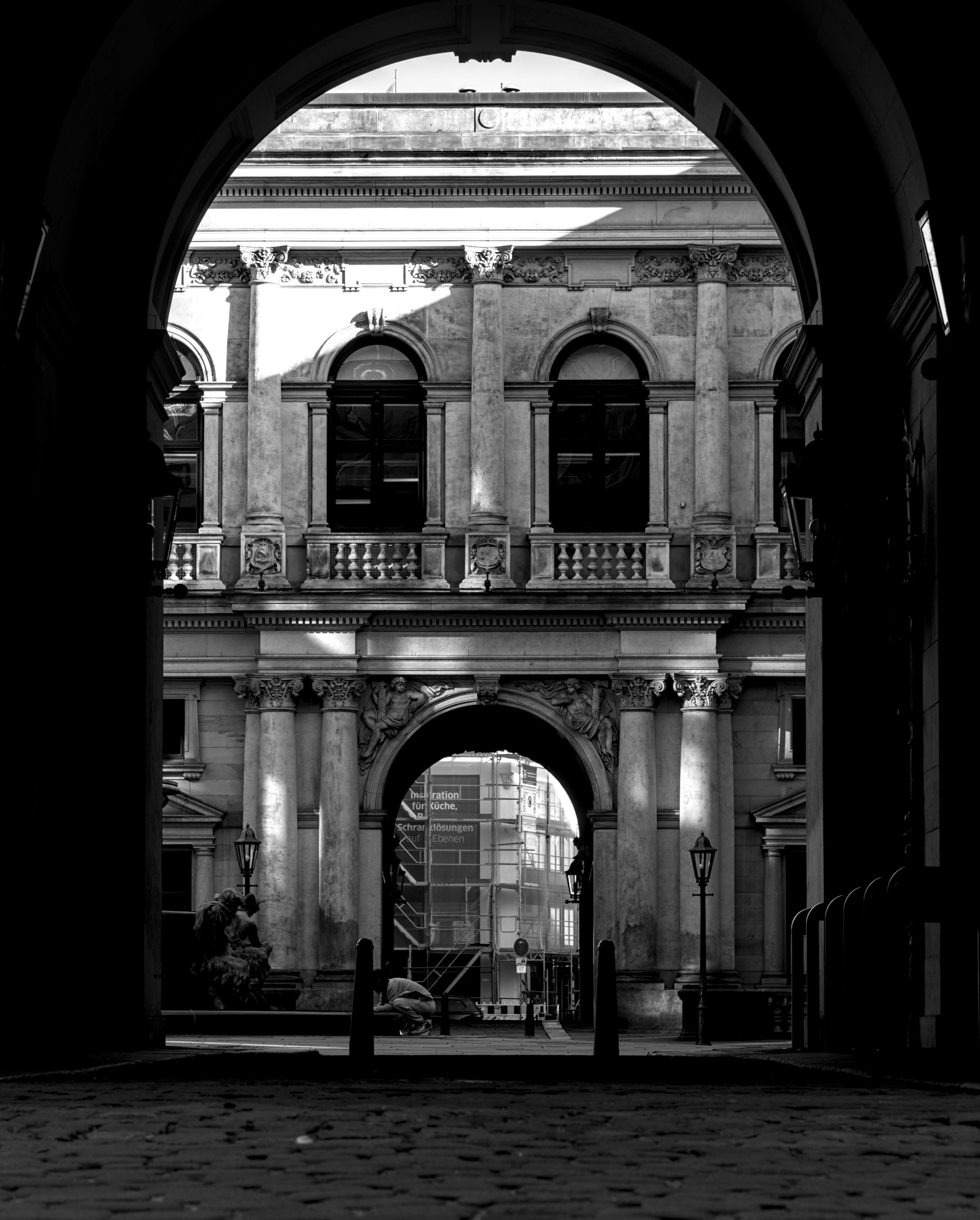 Blick durch einen Torbogen in einen Innenhof, auf der gegenüberliegenden Seite ist ein weiterer Torbogen.